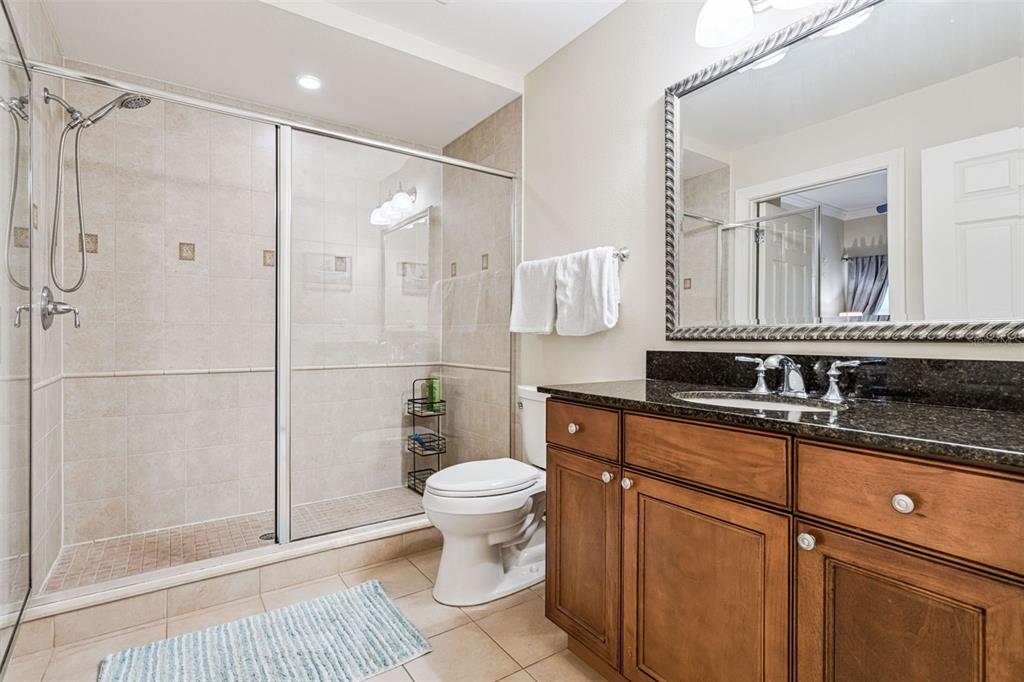 1356 Centre Ct Ridge Drive, Unit 202 Reunion, FL 34747 - Photo 28 of 67 a bathroom with a sink toilet a mirror and shower