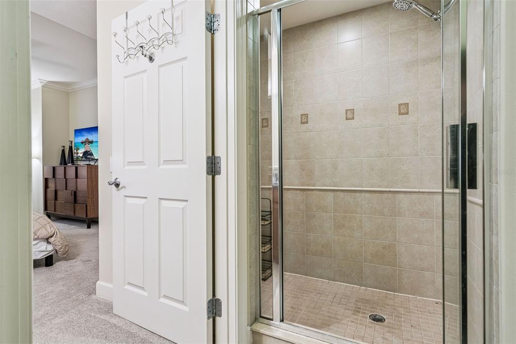1356 Centre Ct Ridge Drive, Unit 202 Reunion, FL 34747 - Photo 29 of 67 a bathroom with a glass shower door