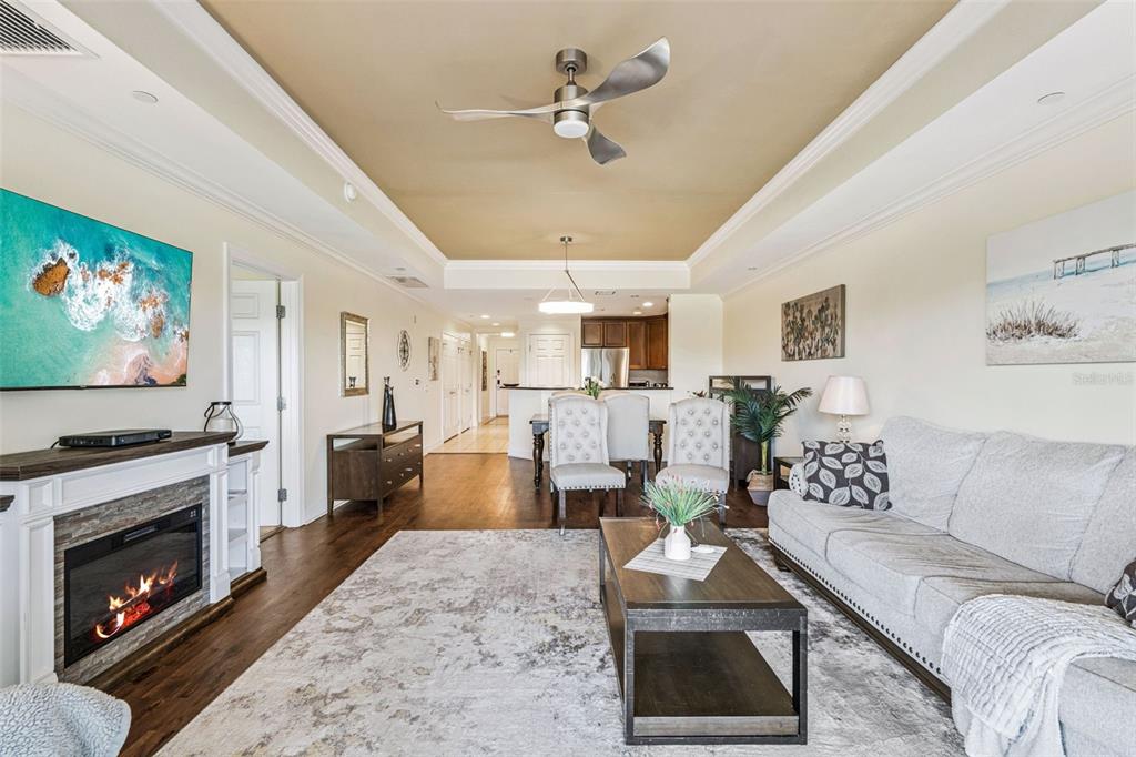 1356 Centre Ct Ridge Drive, Unit 202 Reunion, FL 34747 - Photo 3 of 67 a living room with furniture a fireplace and a flat screen tv