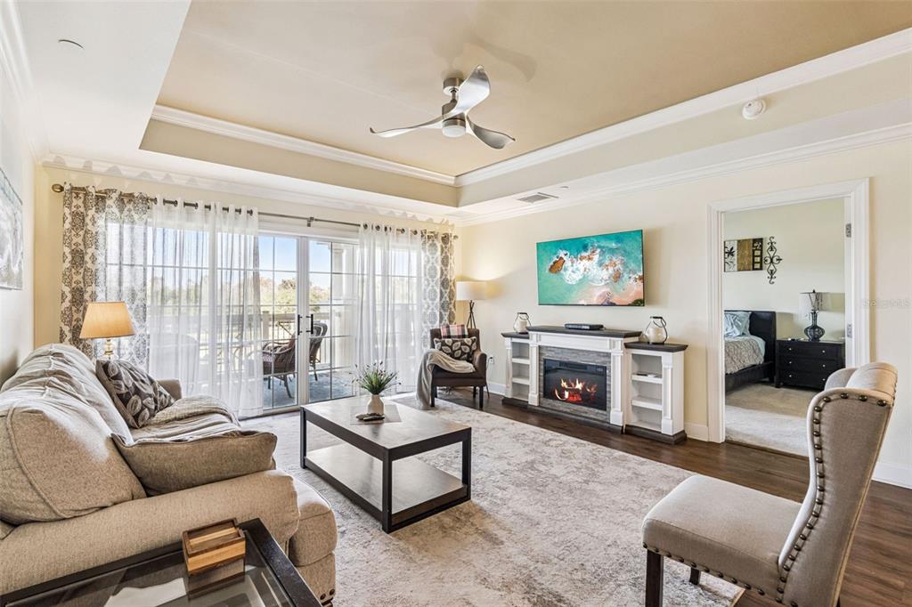 1356 Centre Ct Ridge Drive, Unit 202 Reunion, FL 34747 - Photo 9 of 67 a living room with furniture a flat screen tv and a fireplace