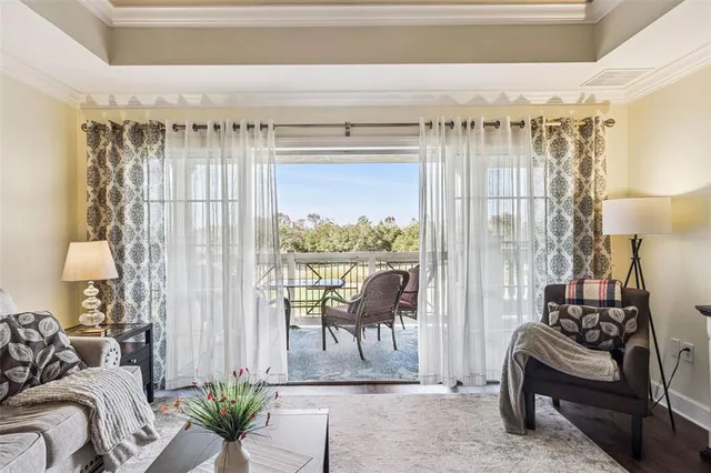 a kitchen with stainless steel appliances granite countertop a table chairs and a refrigerator