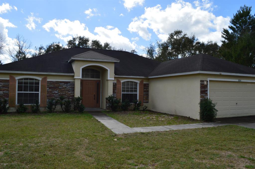 3874 Southwest 131st Place Road Ocala, FL 34473 - Photo 1 of 1 a front view of a house with a garden