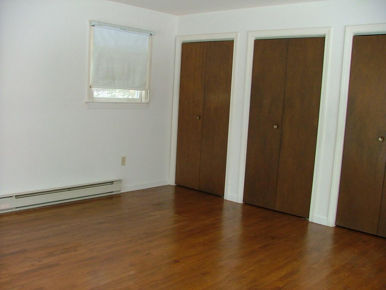 19 Interlaken Cross Road Stockbridge, MA 01262 - Photo 9 of 10 an empty room with wooden floor and windows