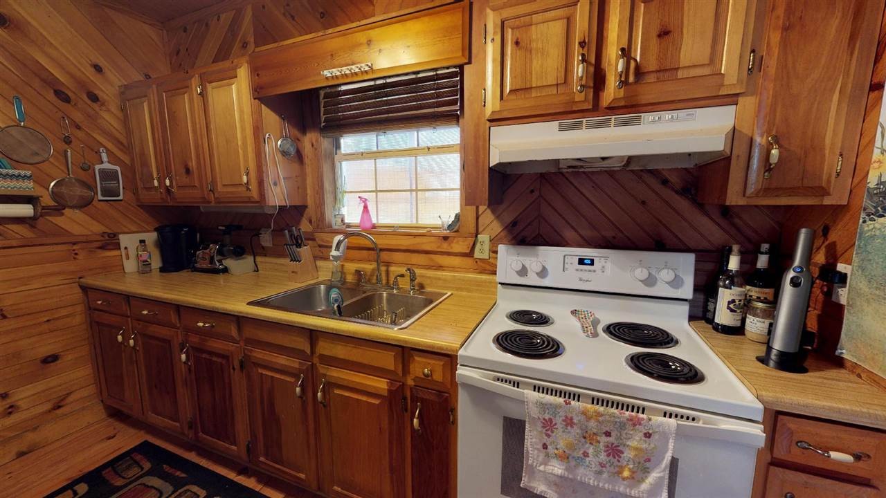 560 Reynolds Bridge Road Ocoee, TN 37361 - Photo 16 of 32 a kitchen with a stove a sink and a microwave