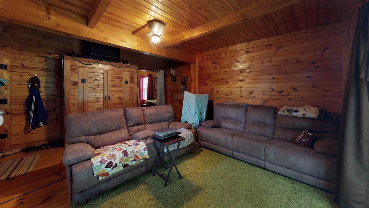 560 Reynolds Bridge Road Ocoee, TN 37361 - Photo 17 of 32 a living room with furniture and a flat screen tv