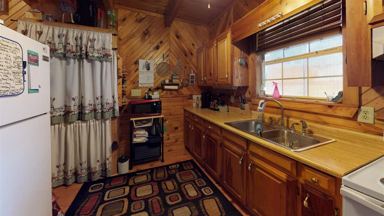 560 Reynolds Bridge Road Ocoee, TN 37361 - Photo 19 of 32 a kitchen with stainless steel appliances granite countertop a sink a stove and a refrigerator