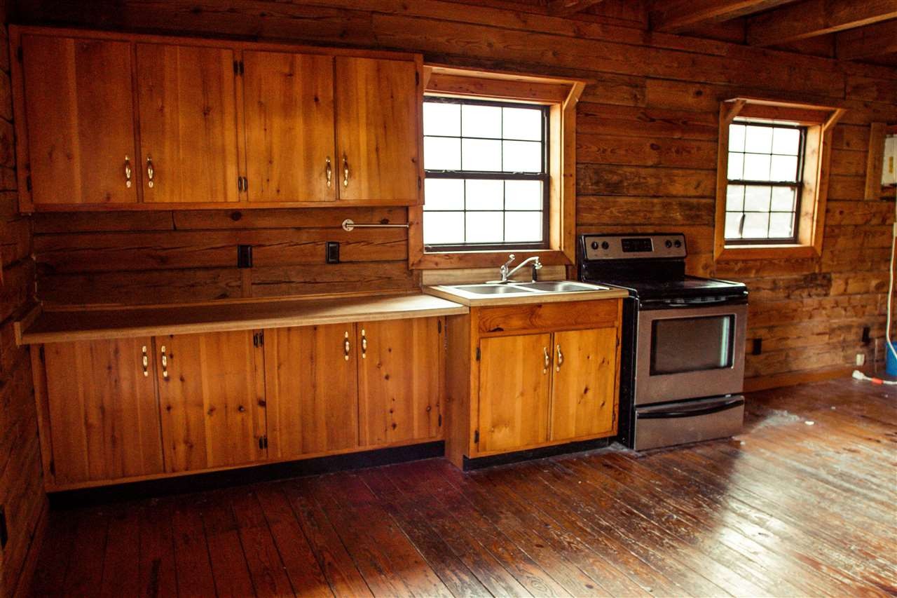 560 Reynolds Bridge Road Ocoee, TN 37361 - Photo 25 of 32 a kitchen with wooden cabinets and a stove top oven
