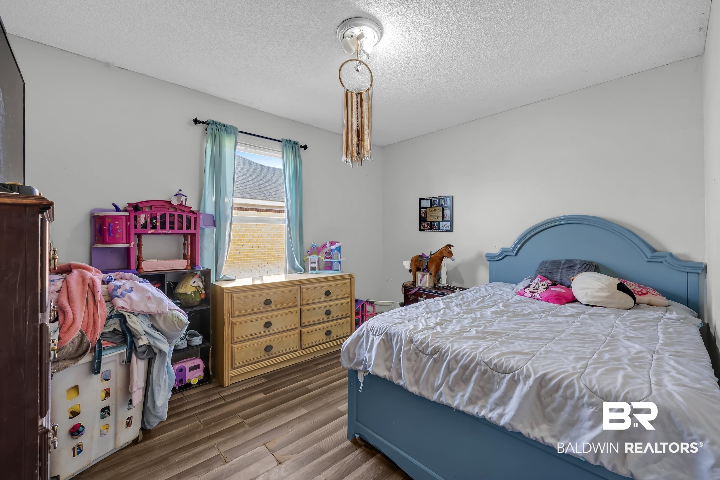 16603 Vanilla Drive Foley, AL 36535 - Photo 12 of 19 Bedroom featuring a textured ceiling and dark wood finished floors