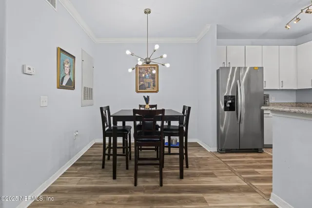 a kitchen with granite countertop a refrigerator stove and sink