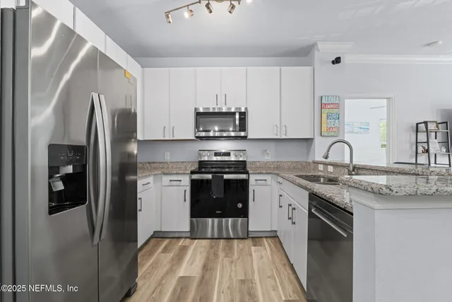 a kitchen with kitchen island a sink and wooden floor