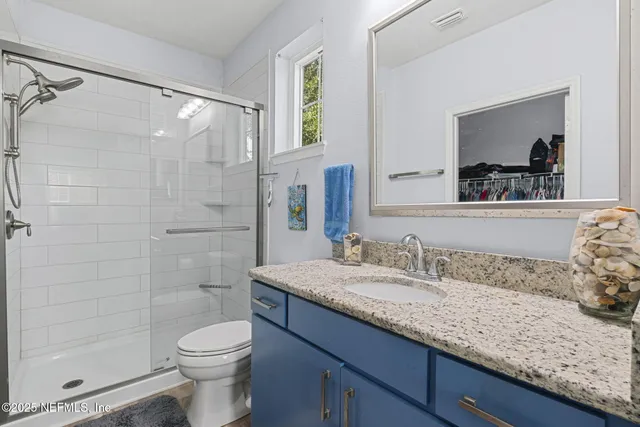 a view of walk in closet with clothes