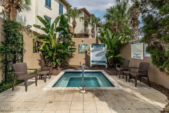 a view of a house with backyard sitting area and swimming pool