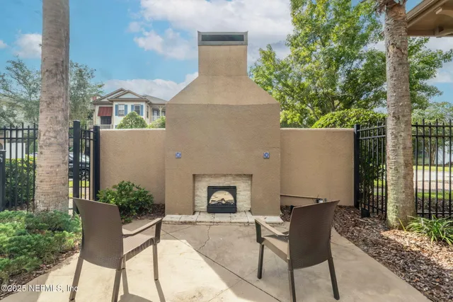 a kitchen with granite countertop white cabinets and a stove