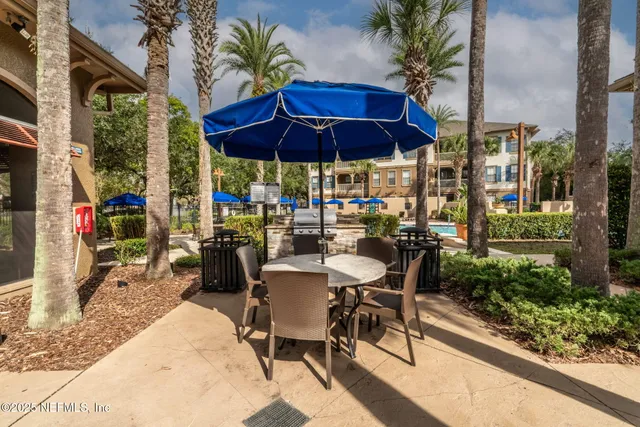 a room with a granite countertop sink and a mirror