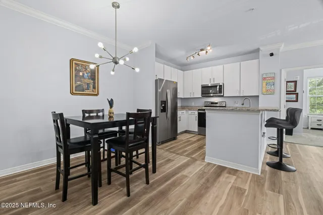 a kitchen with a stove a sink and a refrigerator