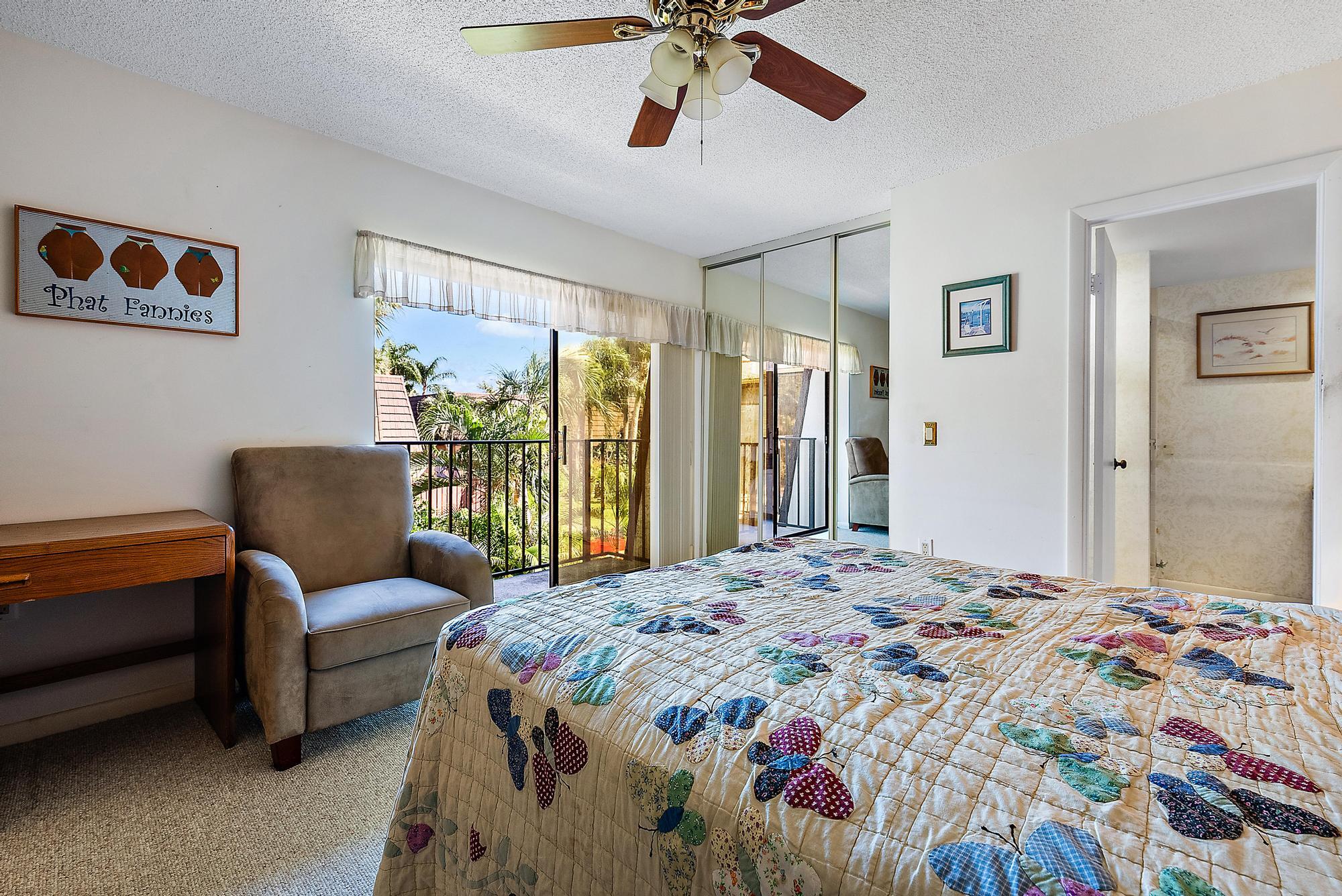 2018 20th Court Jupiter, FL 33477 - Photo 12 of 24 a bedroom with a bed and a chandelier