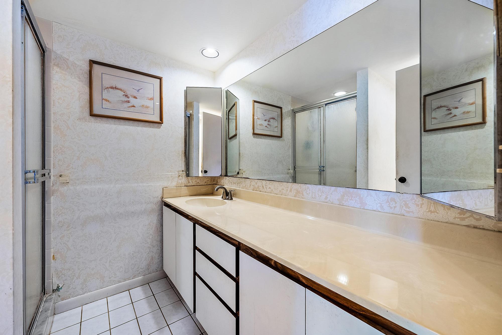 2018 20th Court Jupiter, FL 33477 - Photo 13 of 24 a bathroom with a granite countertop sink