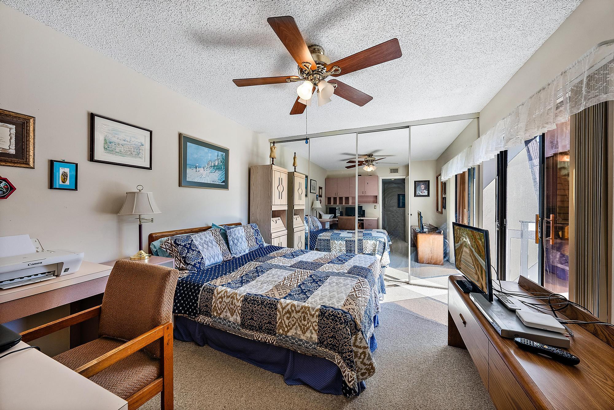 2018 20th Court Jupiter, FL 33477 - Photo 14 of 24 a bedroom with a bed gym equipment and view of living room