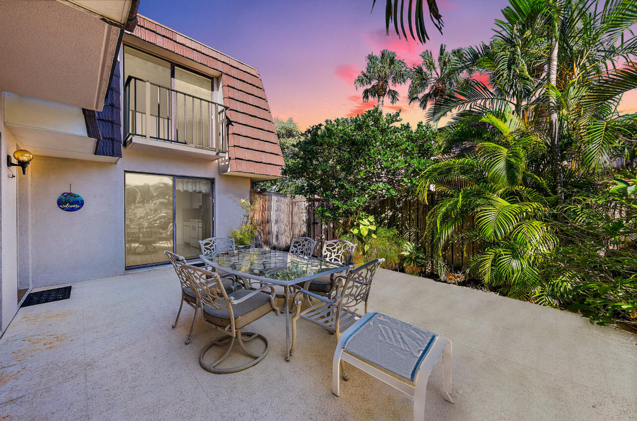 2018 20th Court Jupiter, FL 33477 - Photo 17 of 24 a view of a patio with table and chairs and potted plants