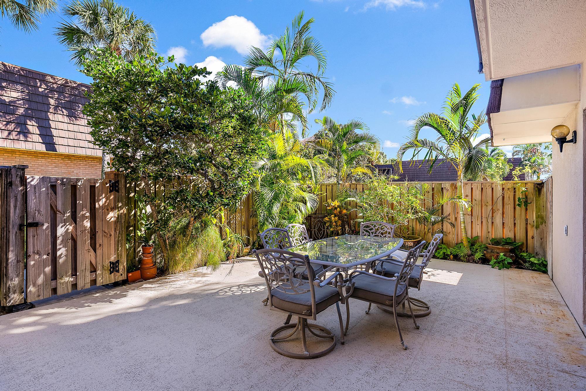 2018 20th Court Jupiter, FL 33477 - Photo 19 of 24 a view of a chairs and table in a backyard