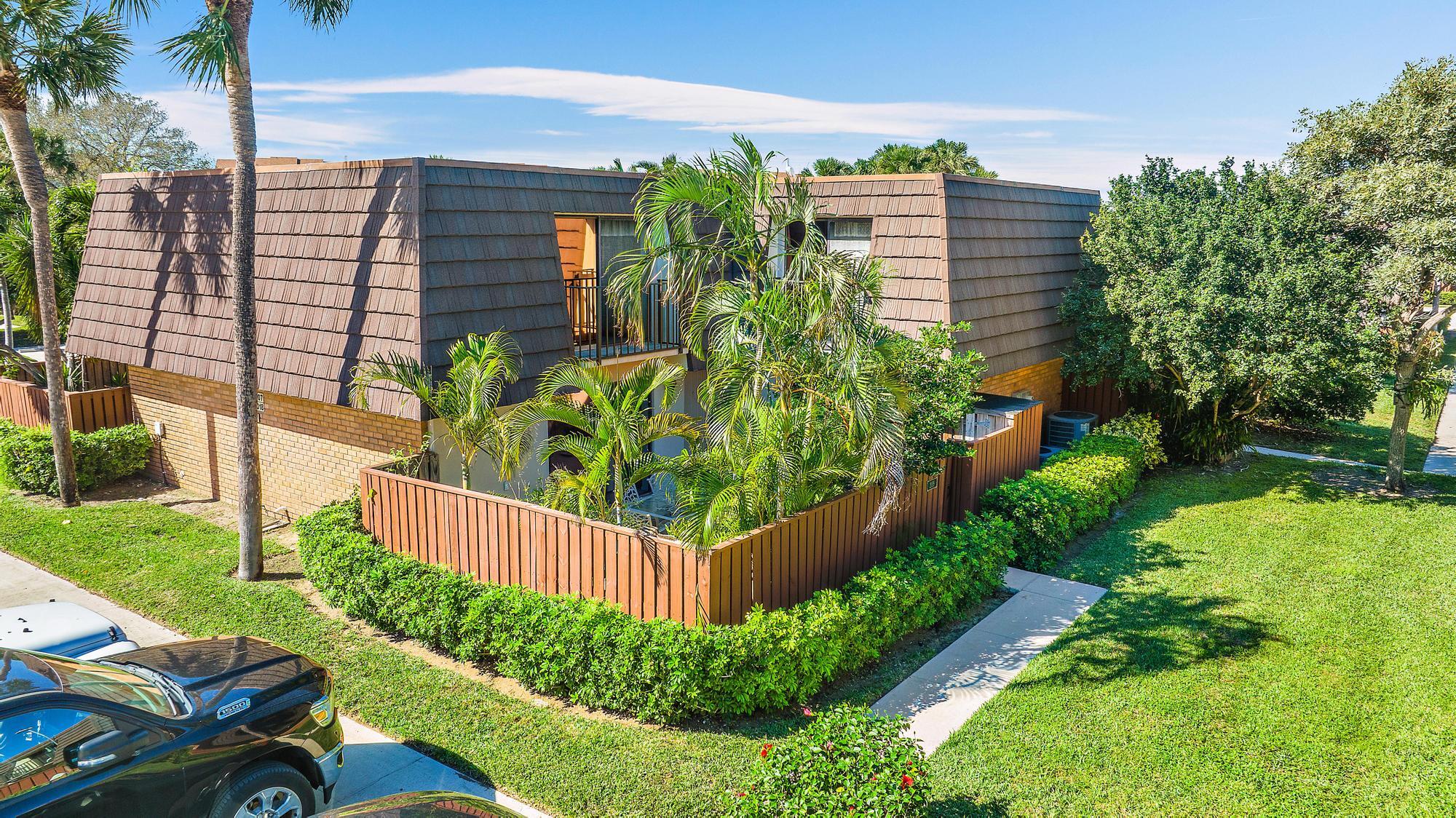 2018 20th Court Jupiter, FL 33477 - Photo 3 of 24 a view of a house with a yard and plants