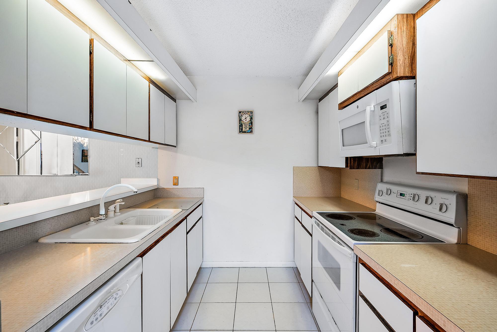2018 20th Court Jupiter, FL 33477 - Photo 6 of 24 a kitchen with stainless steel appliances granite countertop a sink and a stove