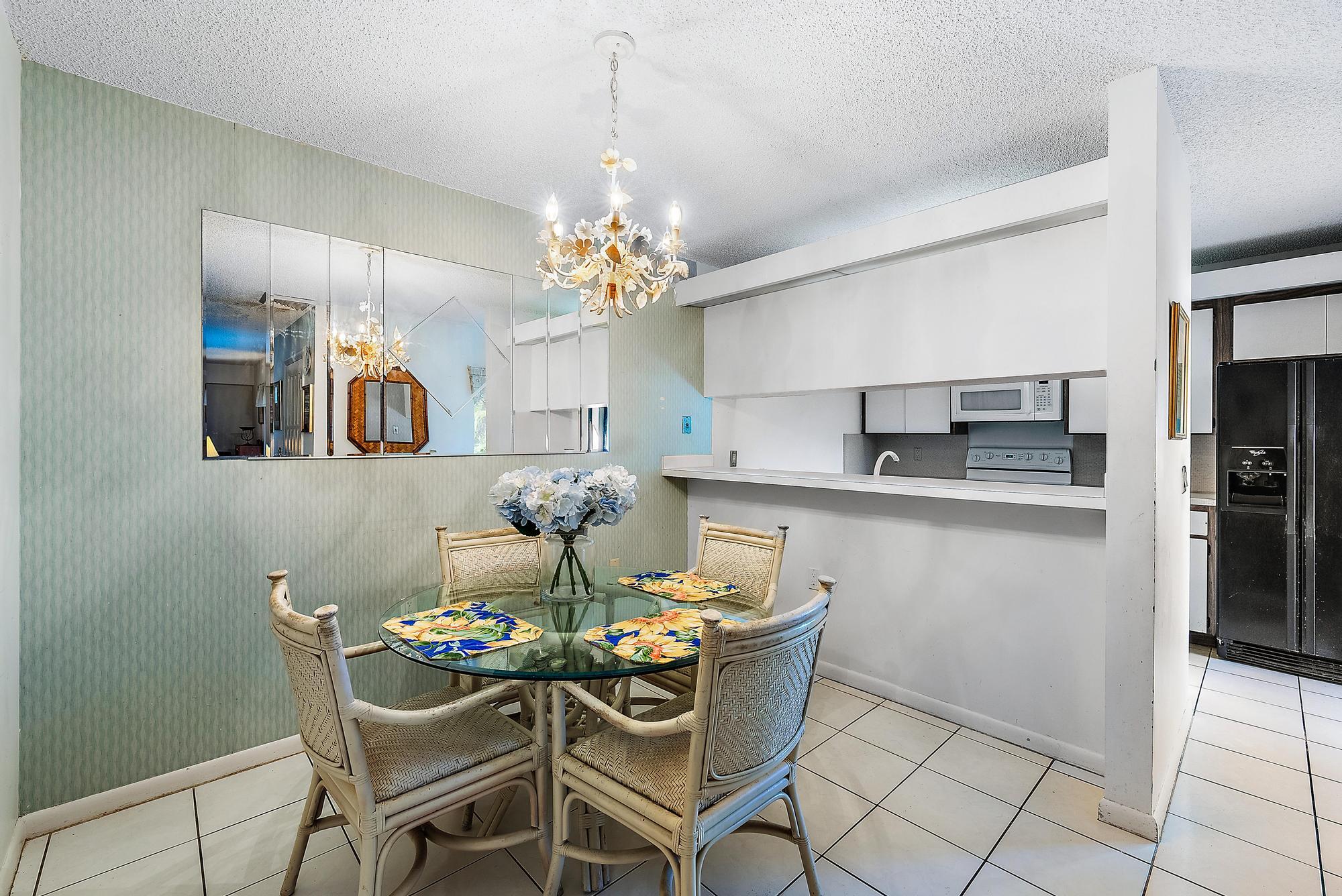 2018 20th Court Jupiter, FL 33477 - Photo 9 of 24 a dining room filled chandelier and wooden floor