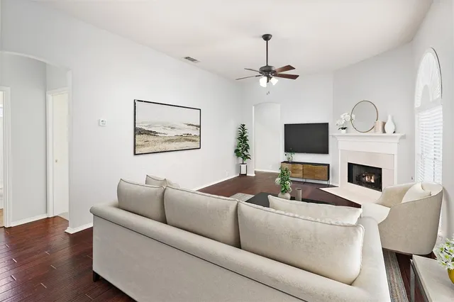 a living room with furniture a fireplace and a flat screen tv