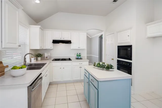 a kitchen with a sink stove and cabinets