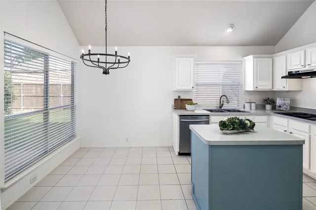 a kitchen with granite countertop stainless steel appliances a sink a counter top space cabinets and a window