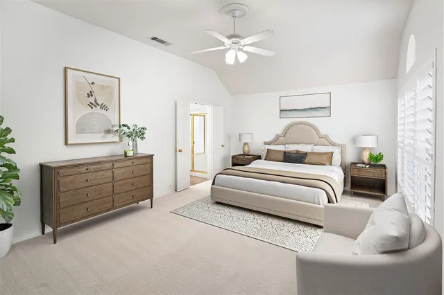 an empty room with a chandelier fan and windows