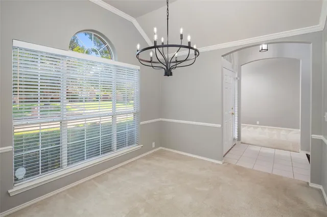 a view of empty room with windows and fan