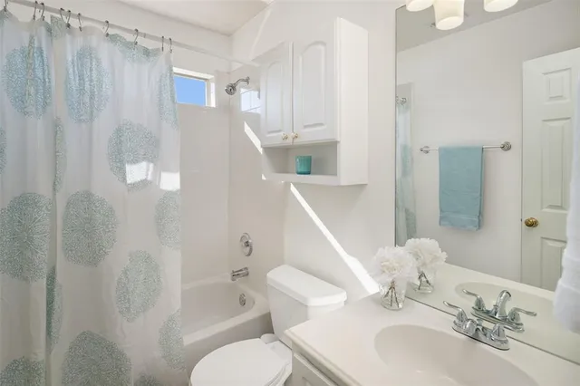 an empty room with closet and a chandelier fan