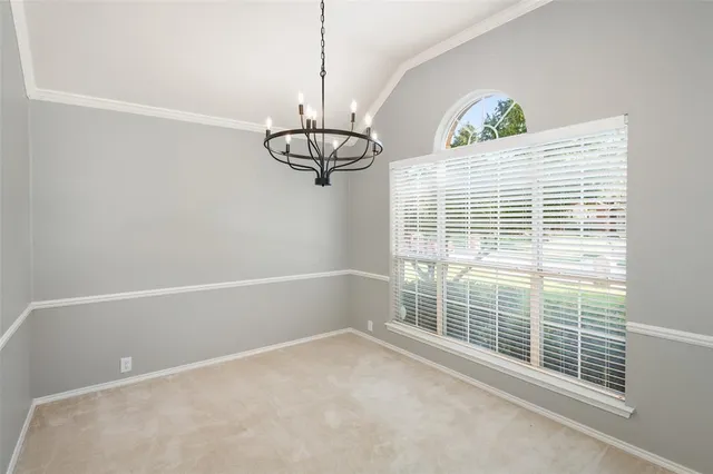a view of a room with windows and ceiling fan