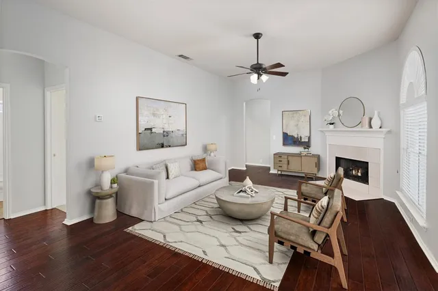 a living room with furniture a fireplace and a table