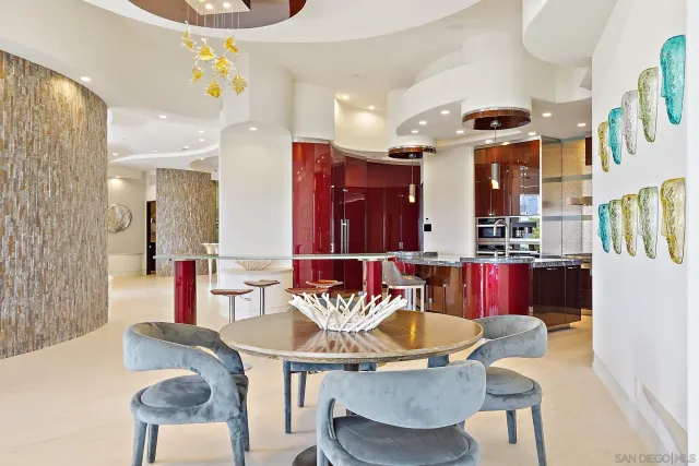 a view of a dining room with furniture and a chandelier