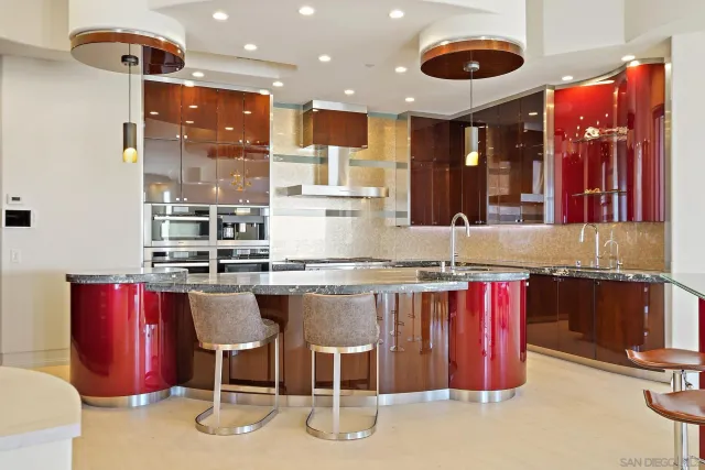 a kitchen with stainless steel appliances granite countertop a sink and a refrigerator