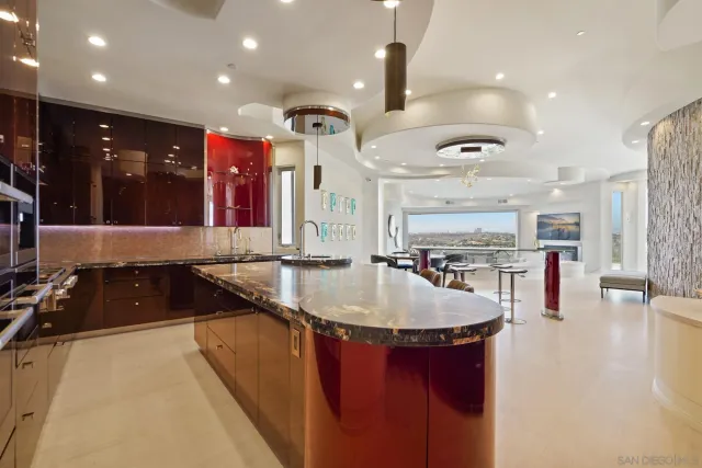 a kitchen with stainless steel appliances granite countertop a sink a oven and a view of living room