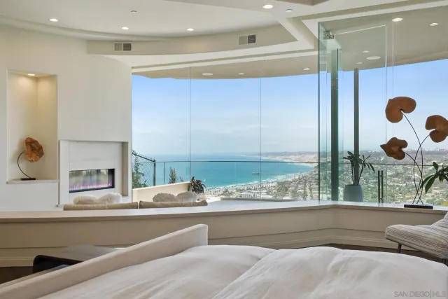 a kitchen with a large window and brick wall