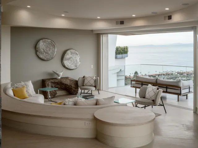 a living room with furniture and a floor to ceiling window