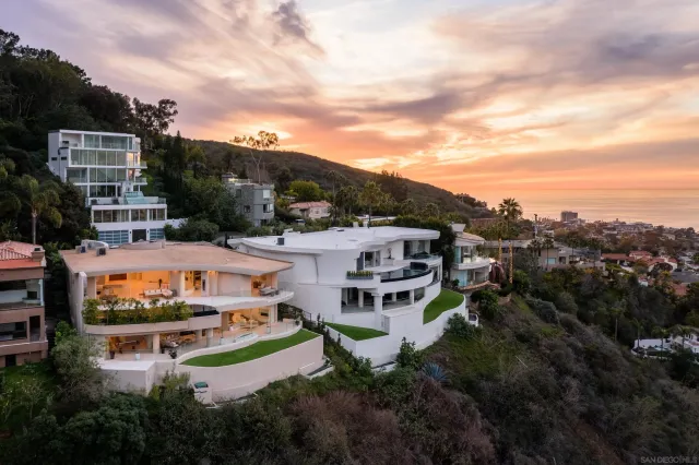 a view of a swimming pool with lawn chairs under an umbrella