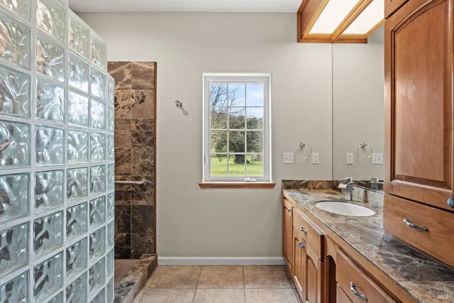 a aerial view of a house with a big yard and potted plants