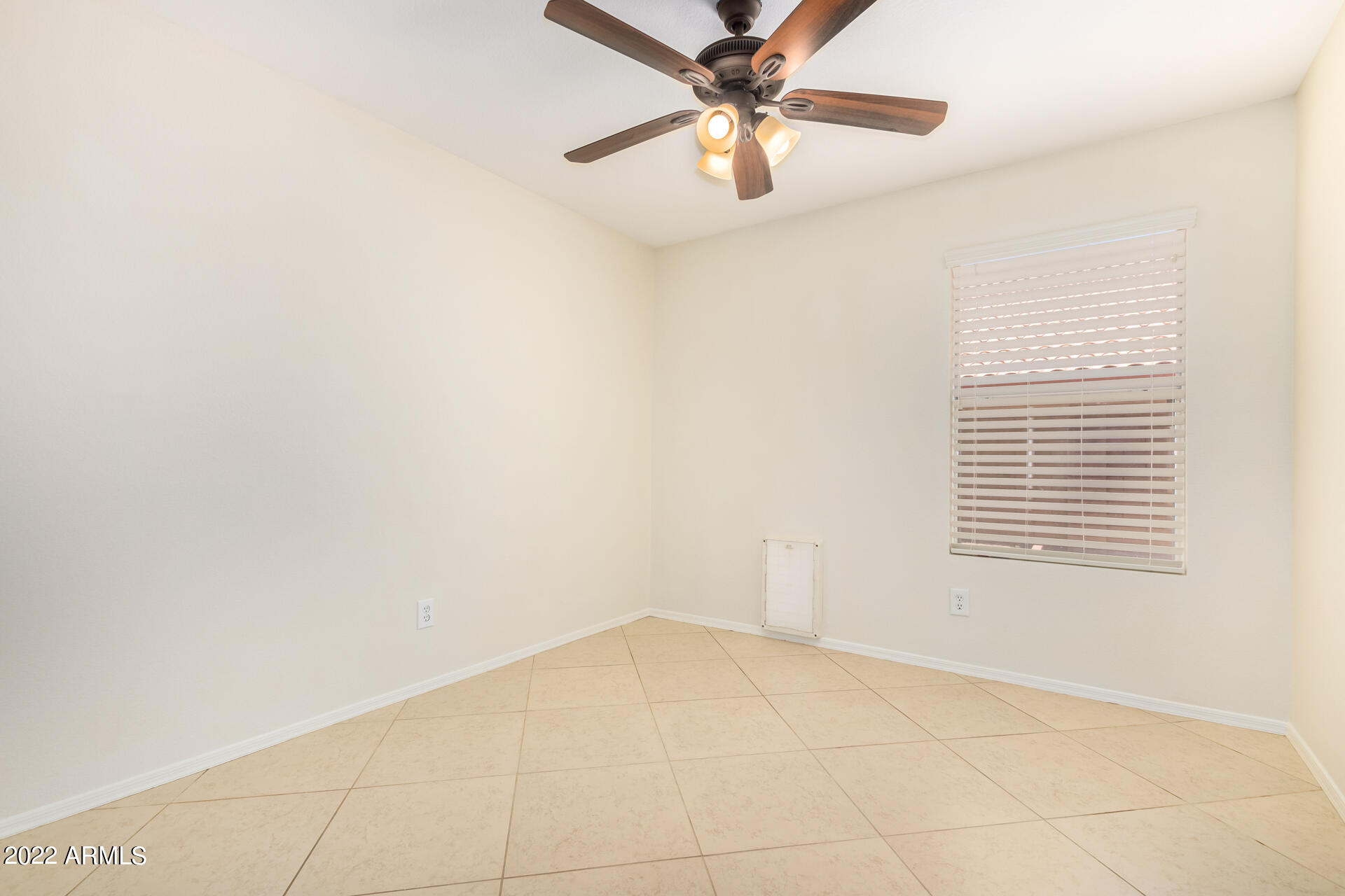 9924 West Burnett Road Peoria, AZ 85382 - Photo 17 of 24 an empty room with a window and a fan