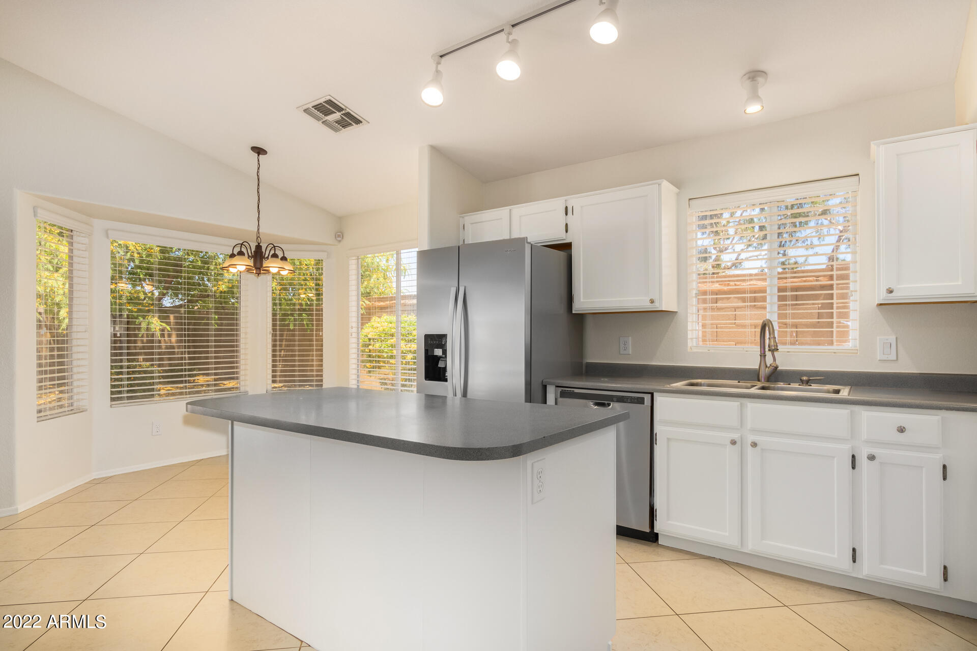 9924 West Burnett Road Peoria, AZ 85382 - Photo 4 of 24 a kitchen with stainless steel appliances granite countertop a sink a stove and a refrigerator