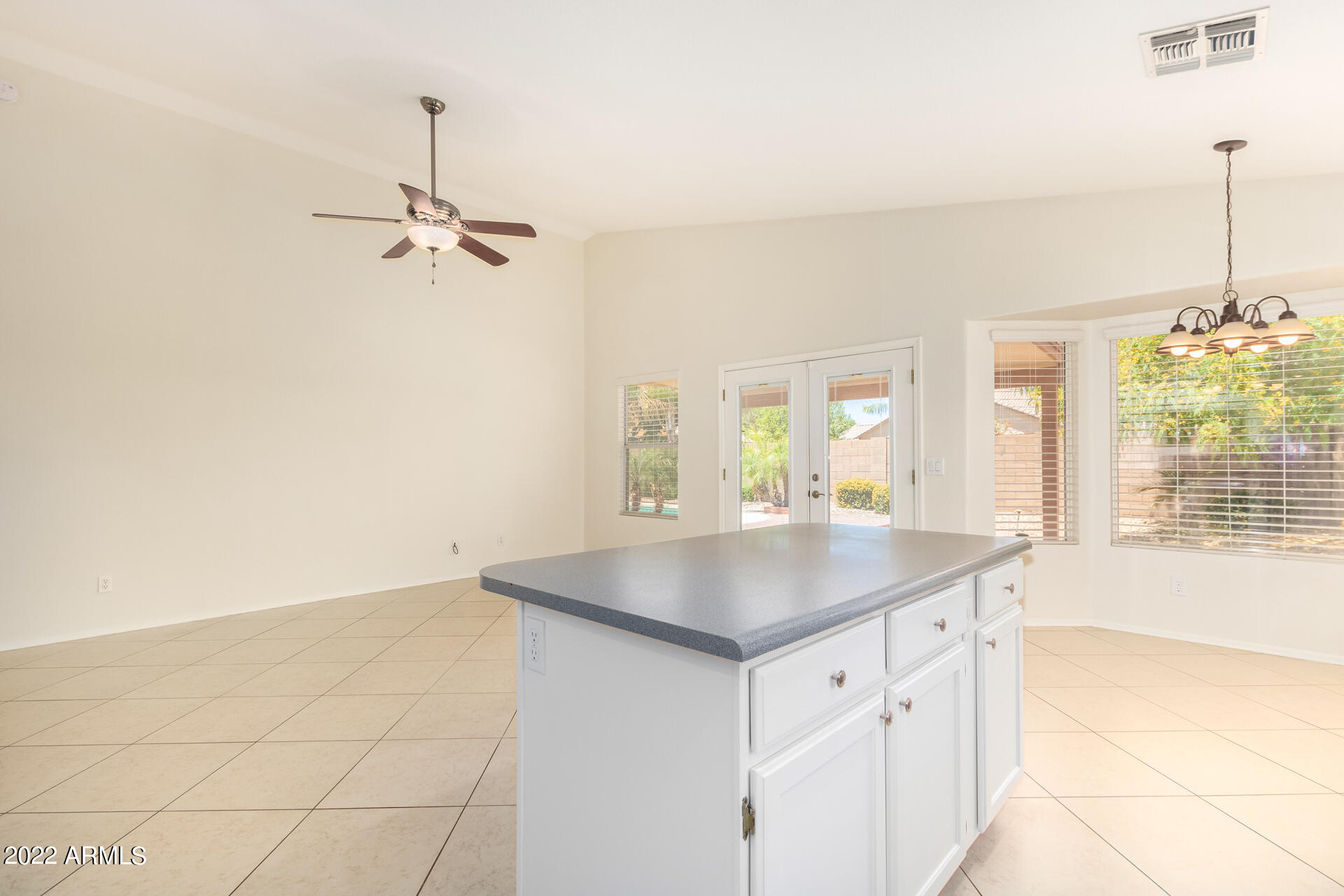 9924 West Burnett Road Peoria, AZ 85382 - Photo 6 of 24 a kitchen with a sink a chandelier and living room view
