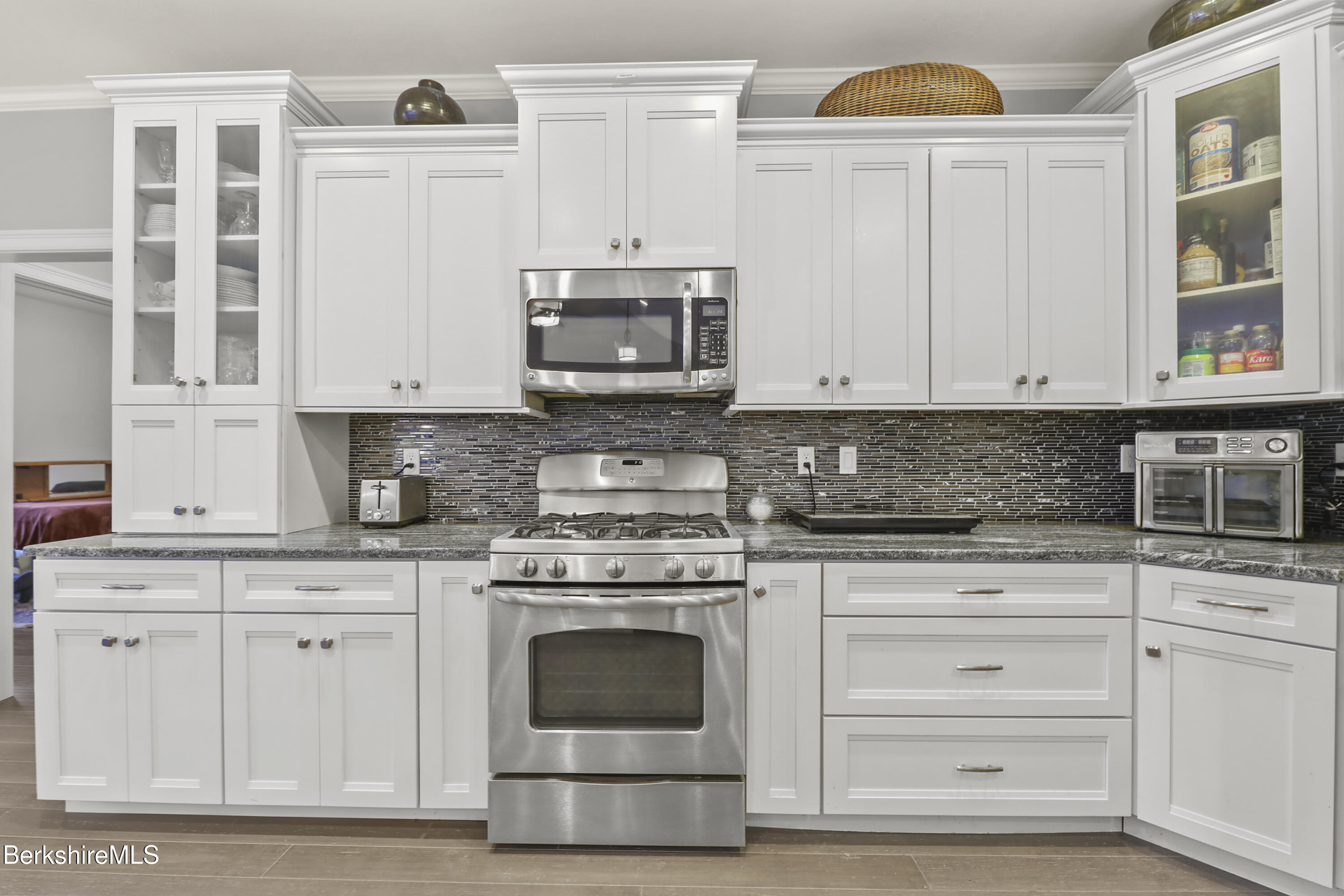 2012 East Otis Road Otis, MA 01029 - Photo 11 of 53 a kitchen with stainless steel appliances granite countertop a stove a sink and a white cabinets