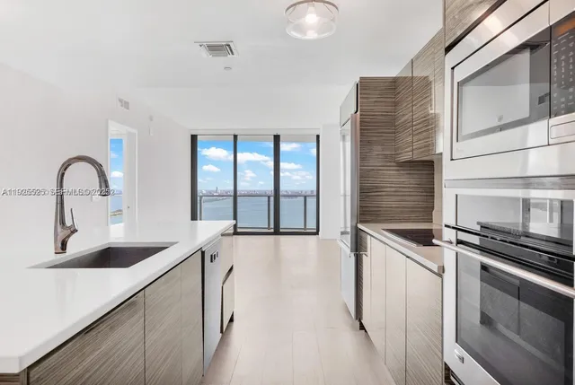 a kitchen with stainless steel appliances a sink and cabinets