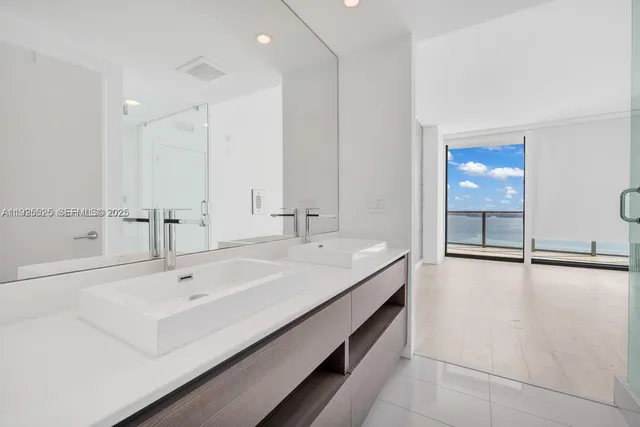 a spacious bathroom with a bathtub and a sink