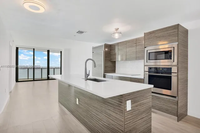 a kitchen with a sink appliances and cabinets