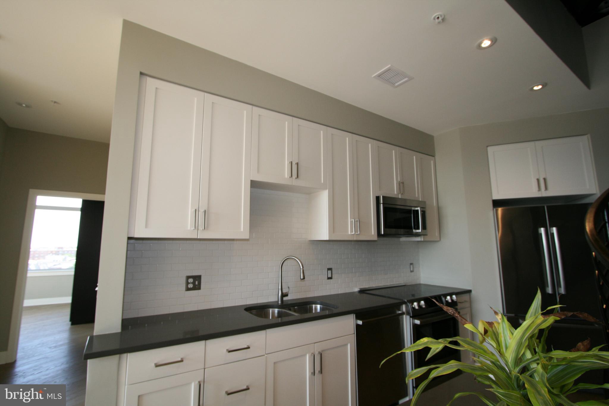 2550 17th Street Northwest, Unit 612 Washington, DC 20009 - Photo 9 of 55 a kitchen with appliances a sink and cabinets